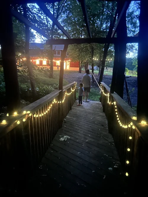 Lit bridge at dusk at Ananda Viplava